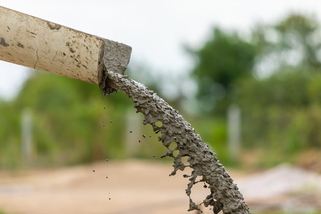 Pouring and sweep the wet cement on the floor in process of house building