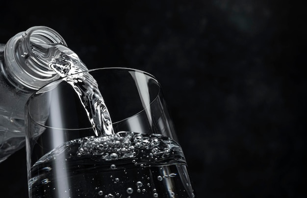 Pouring water on black background