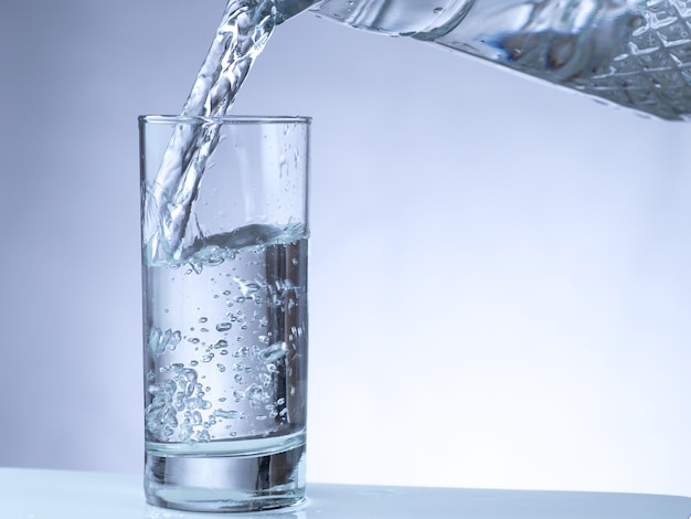 Pouring water from pitcher into a glass