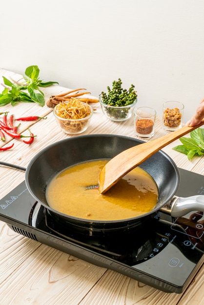 pouring water and sauce on pan