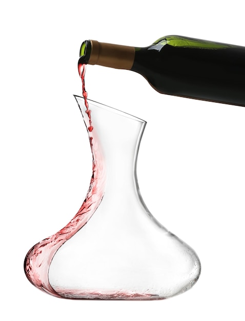 Pouring wine in carafe on white background