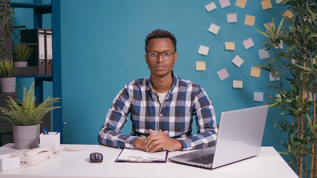 POV of employee attending video call conference at desk, talking to people on remote teleconference. Businessman using online telecommunication on videoconference call meeting. Internet discussion