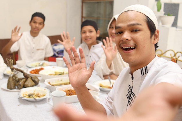 POV of muslim family waving hands gesturing say hi to others family during Eid Mubarak