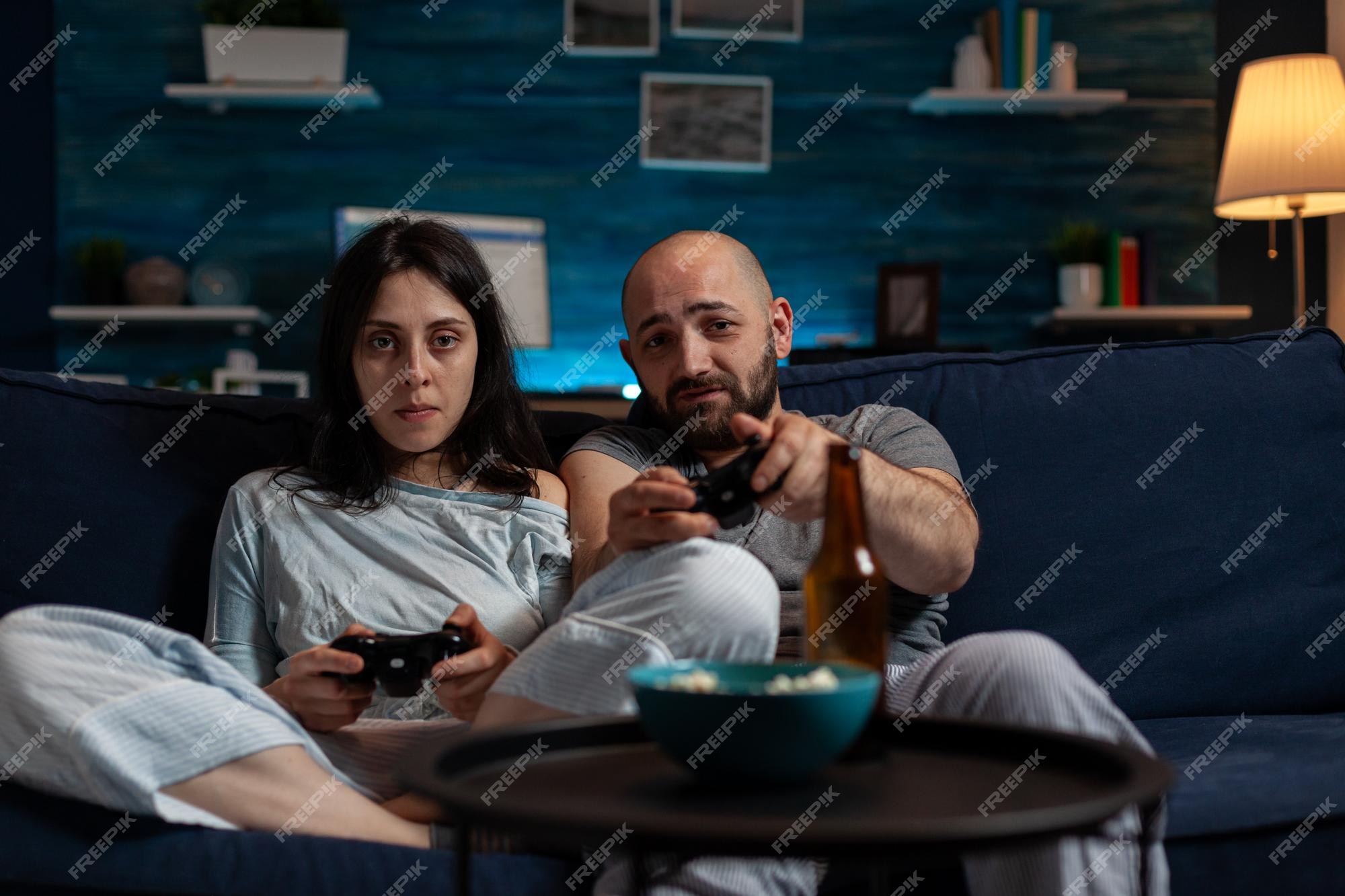 Premium Photo  Pov of young couple using console to play videogames  challenge, doing online competition on cyberspace. focused boyfriend and girlfriend  playing together to do fun leisure activity.