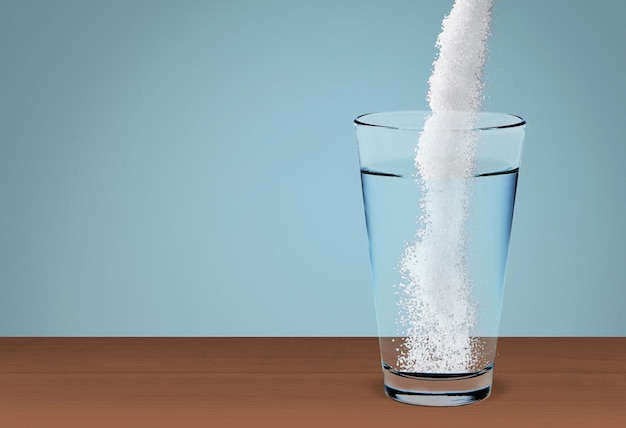 Powder being poured into glass with water