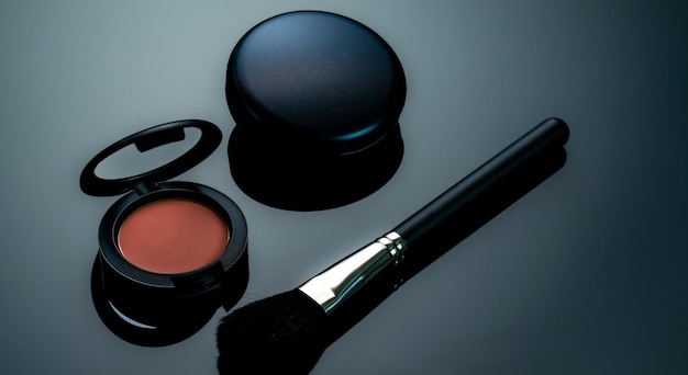 Powder blush powder foundation and makeup brush on black background Cosmetic products Makeup