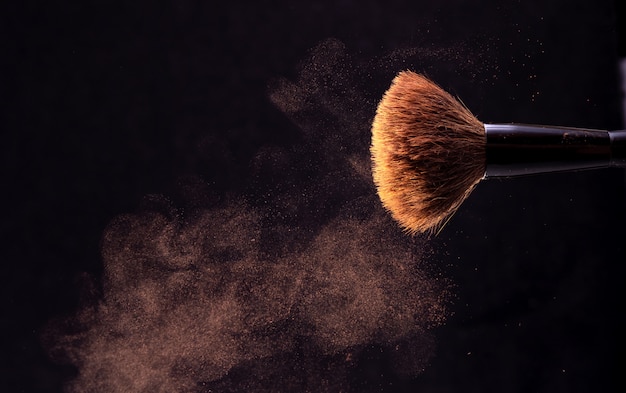 Photo powder brush and dry powder on dark background