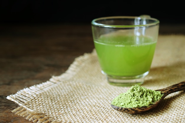 Powder green tea and green tea on table.                               