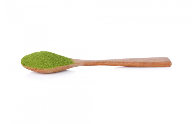 Powder green tea with bamboo spoon isolated on white