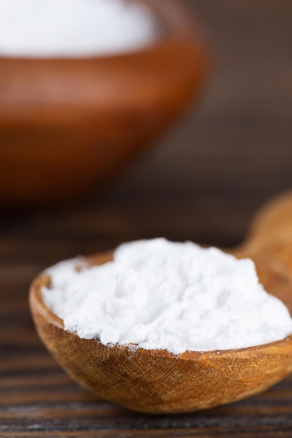 Powdered tapioca starch in a wooden spoon dry cassava root