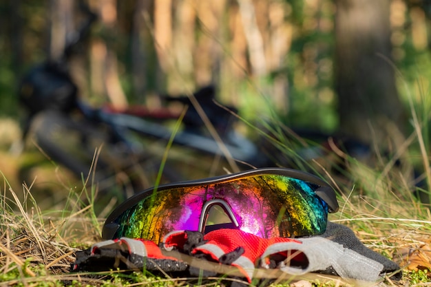 Power bank charges a smartphone in the forest on the background of a bicycle.