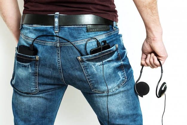 Photo power bank and smartphone in the back pocket of jeans.