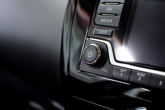 Power button on multimedia dashboard in a car.