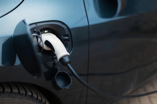 Power cable of plug-in hybrid car on charging station.