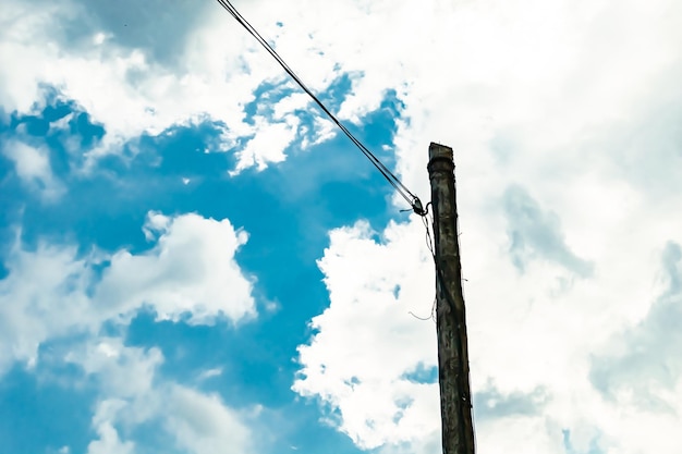 Power electric pole with line wire on colored background close up