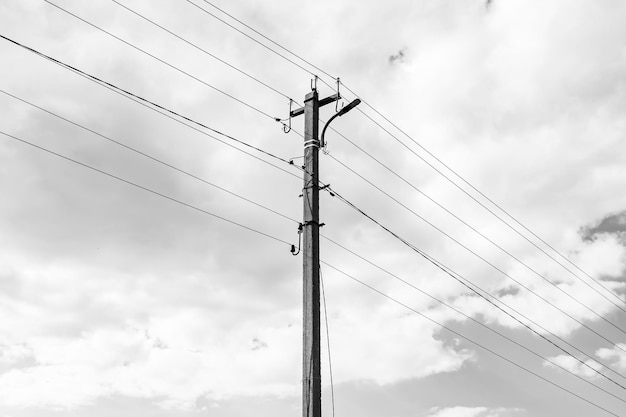 Power electric pole with line wire on dark background close up