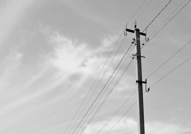 Power electric pole with line wire on light background close up photography consisting of power electric pole with line wire under sky line wire in power electric pole for residential buildings