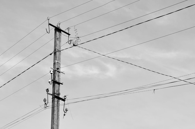 Power electric pole with line wire on light background close up photography consisting of power electric pole with line wire under sky line wire in power electric pole for residential buildings