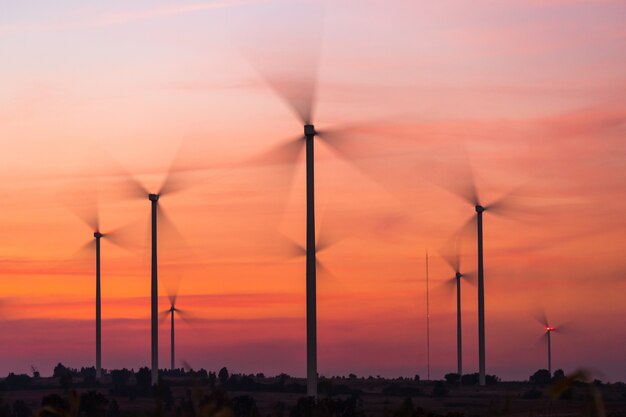 Power generating wind turbines at sunset