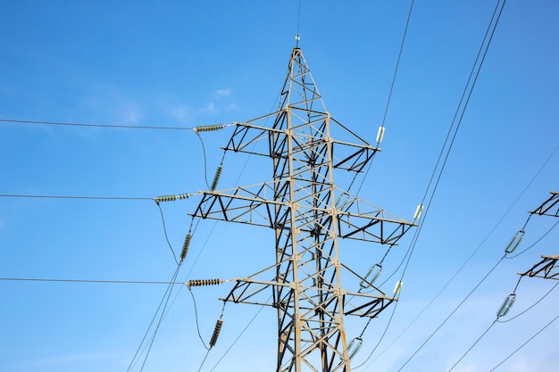 Power line support with wires for electricity transmission High voltage grid tower with wire cable at distribution station Energy industry