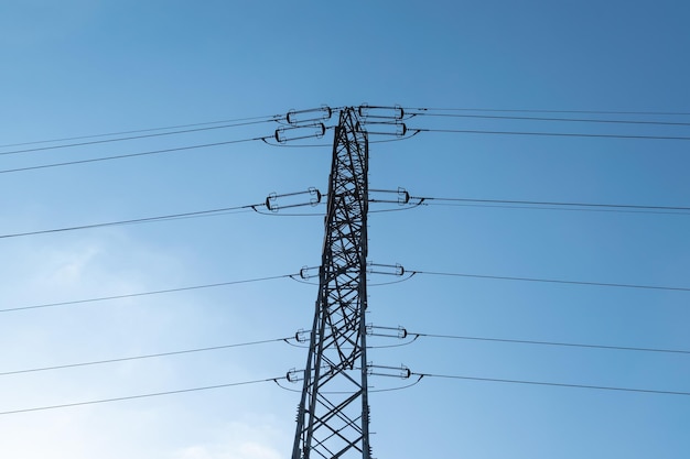 Photo power lines against a blue sky electricity and technology