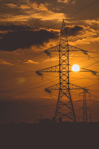 Power lines high voltage on beautiful sunset.