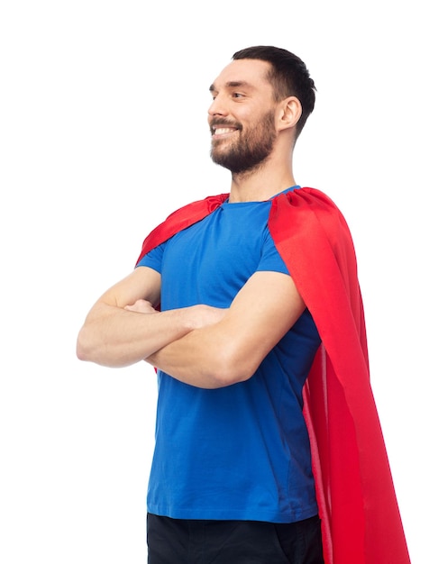 power and people concept - happy man in red superhero cape over white