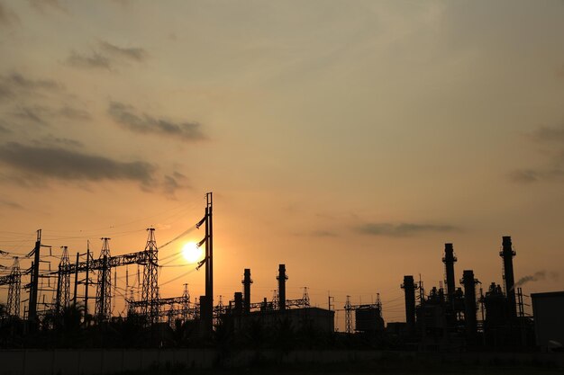 Foto centrale elettrica contro il tramonto della luce arancione con il concetto di energia pulita