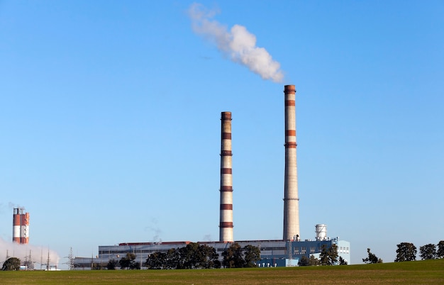 Photo power plant with smoke pipe during operation.