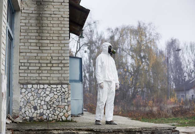 Power plant worker standing on doorstep of old building