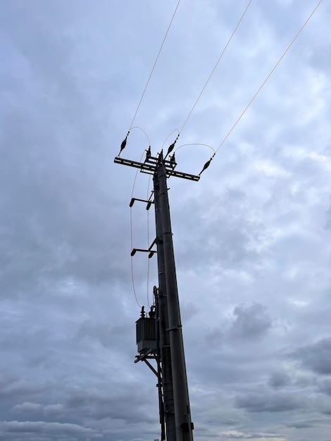 A power pole with a box of wires on it