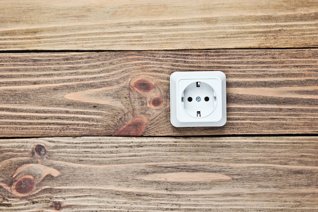 Power socket on wooden wall, 