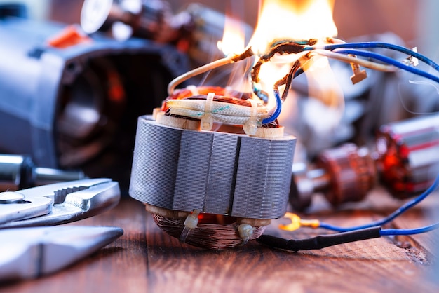 Power tool repair. details of electrical appliance and repair\
tools on a wooden table in a repair shop.