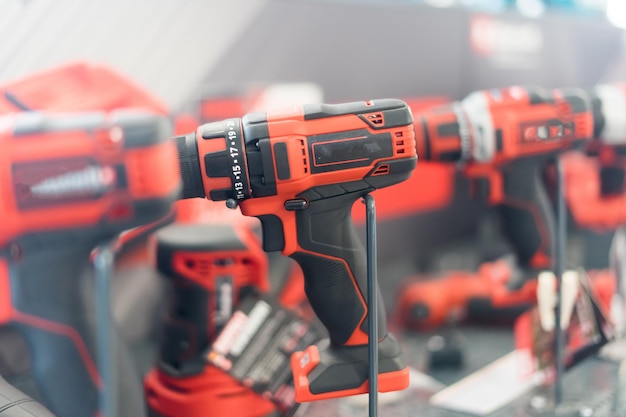 Photo power tools drills and hammers of various manufacturers are sold in a hardware store