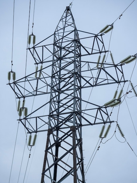 Power tower close-up against a gray sky in winter. Power transmission and communication technologies. horizontal photo