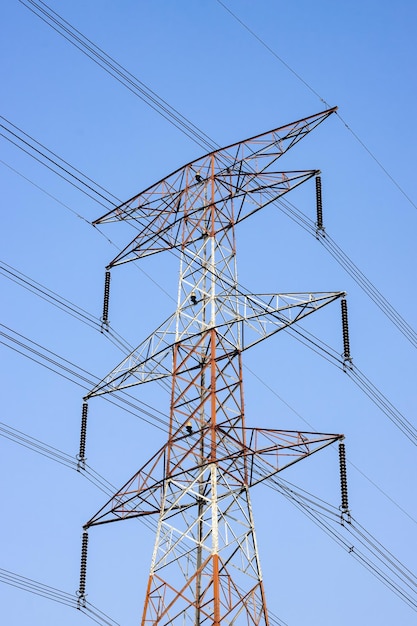 Power transmission tower close up shot under the blue sky