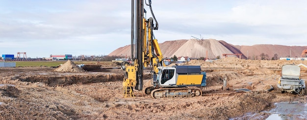 A powerful drilling rig for peeling at a construction site. Operation of the drilling rig in northern conditions. Pile foundations. Bored piles. Pagoramic view. Banner format.