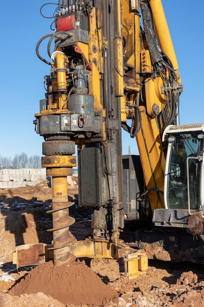 Photo a powerful drilling rig with an auger drills a well at a construction site. pile foundations. bored piles.