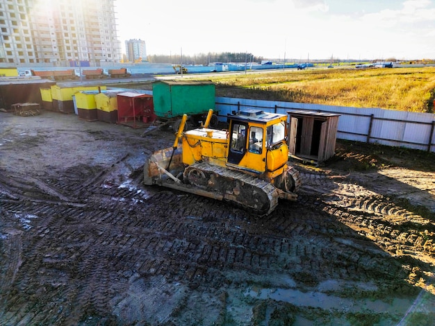 Powerful heavy loader or dozer view from above drone\
photography earthworks with heavy equipment at the construction\
site road construction equipment