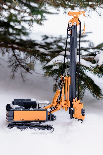 Powerful hydraulic drilling rig for the installation of bored piles in the winter in the snow at the construction site. Drilling rig in northern conditions. Bored piles. Close-up. Selective focus.