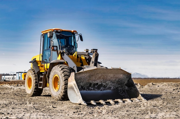 Powerful wheel loader or bulldozer working on a quarry or construction site Earthworks in construction Powerful modern equipment for earthworks