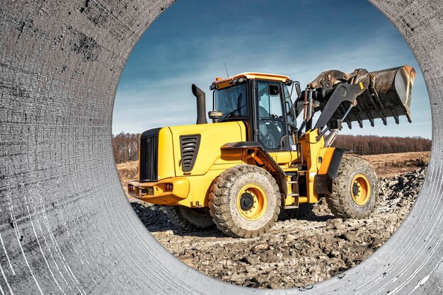 Powerful wheel loader or bulldozer working on a quarry or construction site Earthworks in construction Powerful modern equipment for earthworks