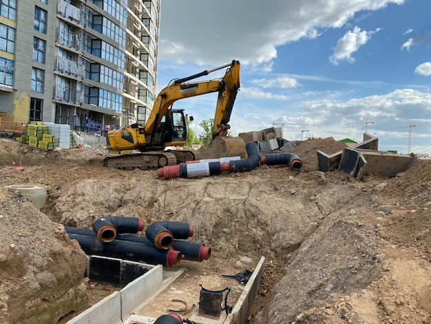 Powerful yellow industrial professional excavator doing earthwork underground repair work