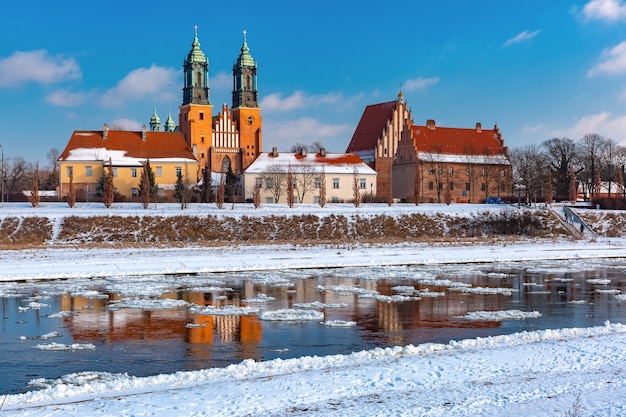 Poznan Cathedral and ice drift on Warta River in the winter sunny day, Poznan