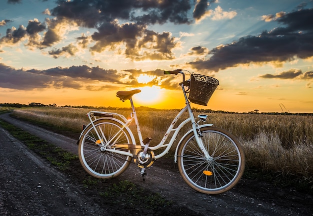 Prachtig landschapsbeeld met een vintage fiets bij zonsondergang