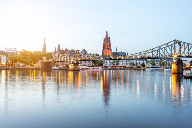 Prachtig stadsgezicht op de verlichte oude stad en de brug tijdens de schemering in Frankfurt, Duitsland