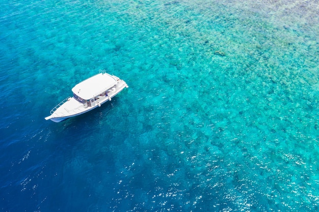 Prachtig turquoise zeewater met boot. Tropisch koraalrif over uitzicht luchtfoto, oceaanlagune