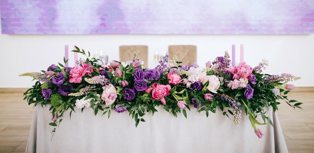 Prachtige bruiloft tafeldecoratie met paarse en roze verse bloemen