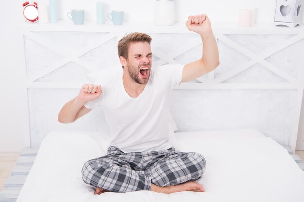 practice calming activities such as meditation before going to bed handsome man relaxing in bed establish regular nightly sleep pattern healthy sleep concept tips promoting healthful sleep habits