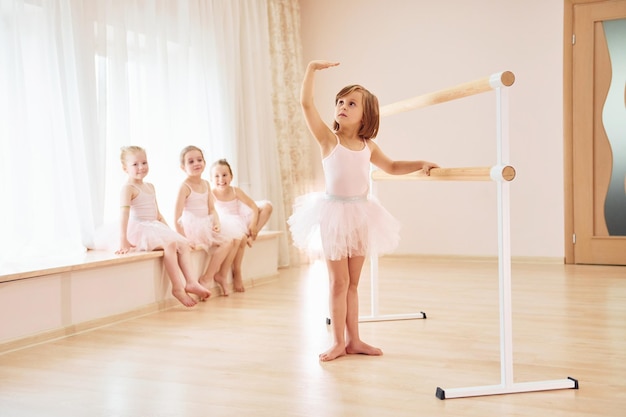 Practicing dance moves Little ballerinas preparing for performance